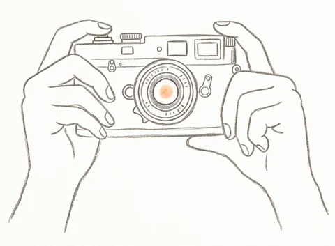 Two hands holding a camera
